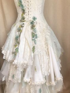 a white dress with flowers and leaves on it