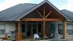 an outside view of a house with a pool in the front yard and covered patio