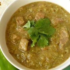 a white bowl filled with soup and garnished with cilantro