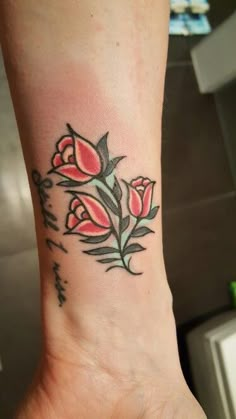 a woman's foot with a flower tattoo on it