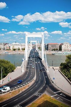 an aerial view of a bridge with cars driving on it