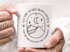 a woman holding a coffee mug with the words to the stars who listen on it