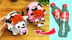 two plastic cows are shown with coca - cola bottles in the foreground and an image of