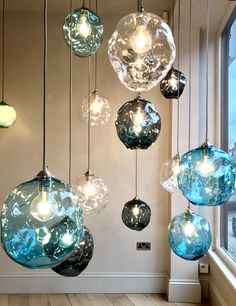 a bunch of glass balls hanging from the ceiling