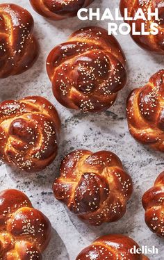 several hot cross buns with sesame seeds on top and the words chalab rolls above them