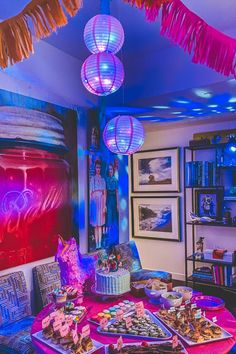 a brightly lit party room with food on the table and decorations hanging from the ceiling