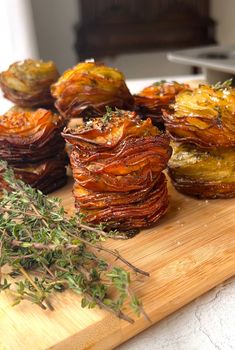 an assortment of cooked vegetables on a cutting board