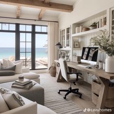 a living room filled with furniture and a large window next to the ocean in front of it