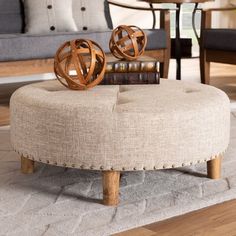 a round ottoman sitting on top of a wooden floor