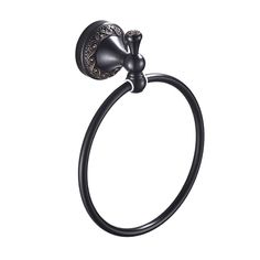 a black towel ring with an ornate design on the front and back end, hanging from a wall