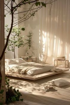 a bed sitting in the middle of a room next to a tree and some plants