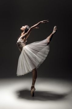 a ballerina in white tutu and ballet shoes