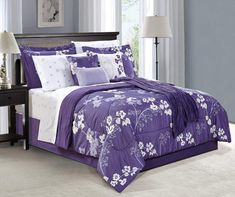 a purple and white bed in a bedroom