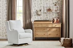 a baby's room with a chair, dresser and wallpapered walls in neutral colors