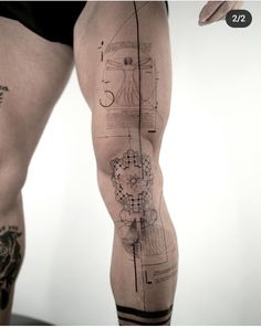 a man's leg with tattoos on it, and the bottom part of his thigh