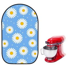 a red mixer next to an oven mitt with white daisies on blue background