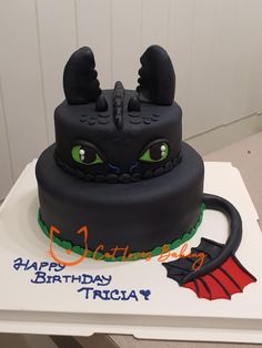 a birthday cake with an image of a dragon on it