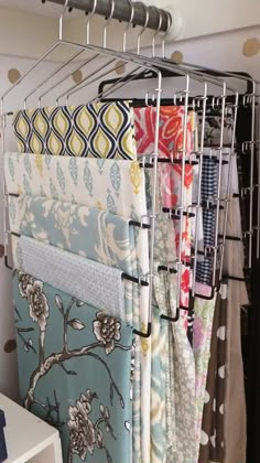 a rack with several different fabrics hanging on it