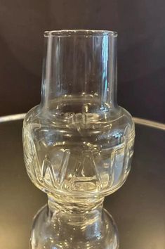 a clear glass vase sitting on top of a table