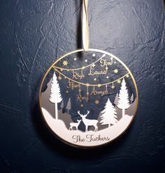 a christmas ornament hanging from the side of a door with trees and stars on it