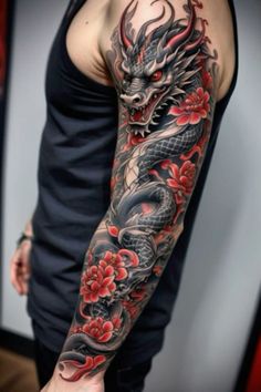 a man with a dragon tattoo on his arm and shoulder, holding onto a red flower