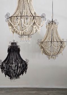 three chandeliers hanging from the ceiling in a room