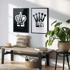 two black and white prints hang on the wall above a bench in a living room