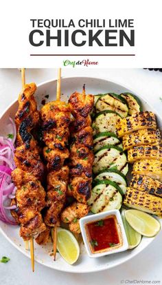 grilled chicken skewers and vegetables on a white plate with dipping sauces