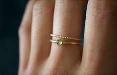 STUNNING handmade peridot ring set✨ * Listing covers both the peridot ring and twisted band. Beautiful 3mm peridot gemstone ✨ Peridot is a crystal that's not only rich in culture and history, but also mysticism and healing power. Peridot is rich with healing energies and spiritual connotations. Peridot can help to boost the confidence of those wearing it, as well as attracting luck and love✨ A beautiful minimalist piece to have in ones collection✨ Perfect for stacking or wearing alone! Material: Dainty Green 14k Gold Stackable Rings, Minimalist Green Stackable Rings For Everyday, Minimalist Everyday Green Stackable Rings, Gold Peridot Stackable Rings As Gift, Dainty Green Ring For Everyday, Gold Stackable Peridot Rings As A Gift, Dainty Green Midi Promise Ring, Gold Stackable Rings With Peridot Birthstone, Dainty Green Round Midi Rings