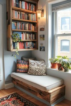 a window seat in front of a book shelf filled with lots of books and plants