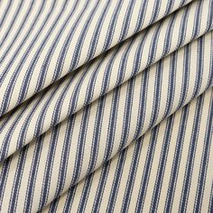 three pieces of blue and white striped fabric on top of each other, with one piece folded