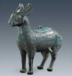 a statue of an animal with intricate designs on it's body