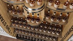 many bottles of wine are on display in a wooden barrel case with metal rims