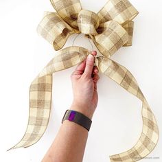 a hand is holding a piece of ribbon