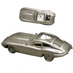 a silver model car with a clock on the top and bottom part of it's body