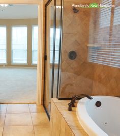 a large bathroom with a walk in shower next to a bathtub