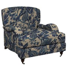 an upholstered chair with blue and white flowers on it