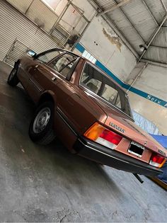 an old car is parked in a garage