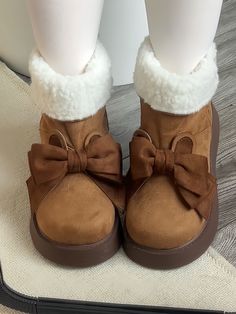 Step into a world of whimsical warmth with our adorable platform snow boots, designed to keep you cozy and stylish all winter long. These charming boots feature a unique thick-soled design for added comfort and height, ensuring you stand out in any snowy landscape. The highlight of these boots is the delightful bunny ear bow embellishment, adding a playful touch that captures the essence of kawaii fashion. The boot's opening is adorned with plush fur trim, providing extra warmth and a luxurious Black Bunny Ears, Roblox Clothes Ideas, Brown Winter Boots, Kawaii Hat, Casual Shoes Women Sneakers, Kawaii Pajamas, Shoes Women Sneakers, Punk Skirt, Ugg Winter Boots