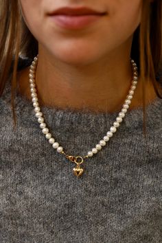 This freshwater pearl necklace features a central clasp with a gold puff heart. Style it with the emory heart necklace featured in the second photo for a love filled look. Details: - Freshwater pearls - Gold filled clasp - Gold plate brass heart charm - 16.5" length SKU: N1100G Materials+Care How To Style Pearl Necklace, Pearl Necklace Outfit, Necklace Outfit, Layered Choker Necklace, Double Wrap Bracelet, Puffed Heart, Gold Pearl Necklace, Freshwater Pearl Necklace, Modern Necklaces