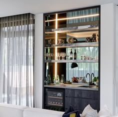 a living room filled with furniture next to a window