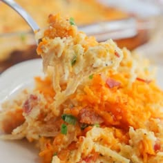 a white plate topped with hash browns covered in cheese