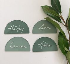 four green glass coasters with names on them