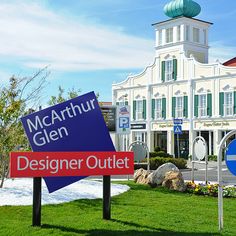 there are two signs in front of the building that says designer outlet and macartuhr glen