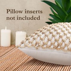 the pillow inserts not included are on display next to two candles and a potted plant