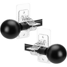 two black door knobs with one ball and the other is on a white background