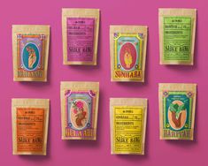 six bags of sunbeam tea on a pink background with the labels in different colors