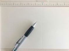 a pen sitting on top of a piece of paper