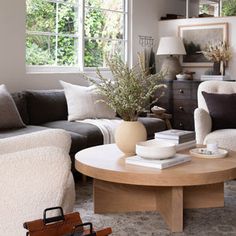 a living room filled with lots of furniture and pillows on top of a coffee table