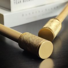 a wooden pen sitting on top of a table next to a book and some books